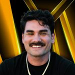 Zakk Colburn, a Fitness Business Coach, is shown in this image. He has dark, wavy hair, a mustache, and is smiling. He is wearing a black shirt and a gold chain necklace. The background features a dynamic design with gold and black diagonal lines.